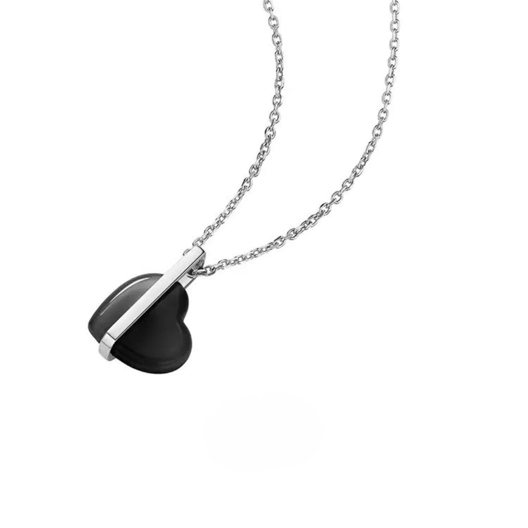 Necklace with a black heart-shaped pendant and 14k white gold bar on a white background