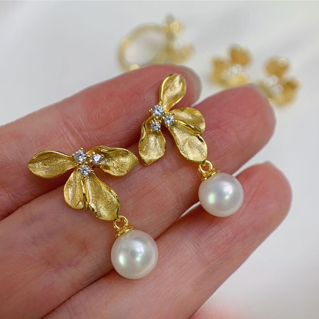 Close-up of Flower Statement Earrings featuring freshwater pearl statement earrings and three sparkling diamonds, perfect as bridal pearl statement earrings and Gold pearl earrings for a statement pearl earrings wedding look.