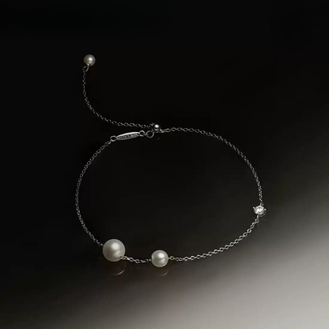 A pearl and diamond bracelet.