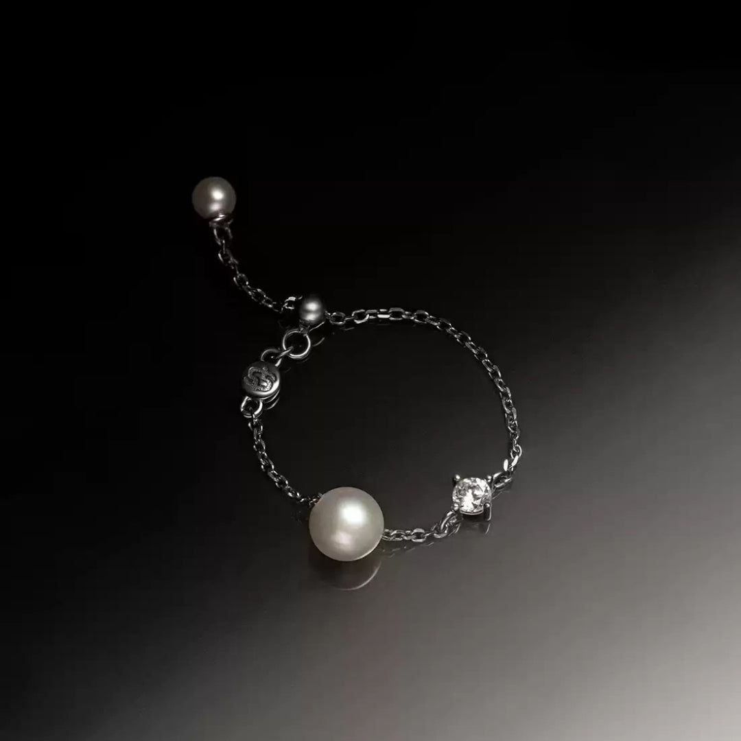 close-up of adjustable silver pearl ring with cultured pearls and zircon stones