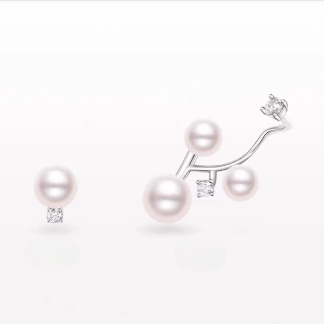 Diamond and Pearl earrings with silver branch design on a white background