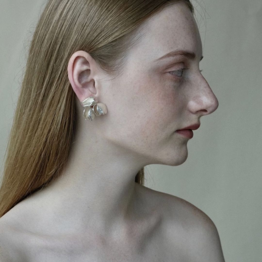 Close-up of Chunky seashell earrings in silver, designed as seashell stud earrings with a chic seashell earrings aesthetic—perfect for ocean jewelry aesthetic and Statement bridal earrings.