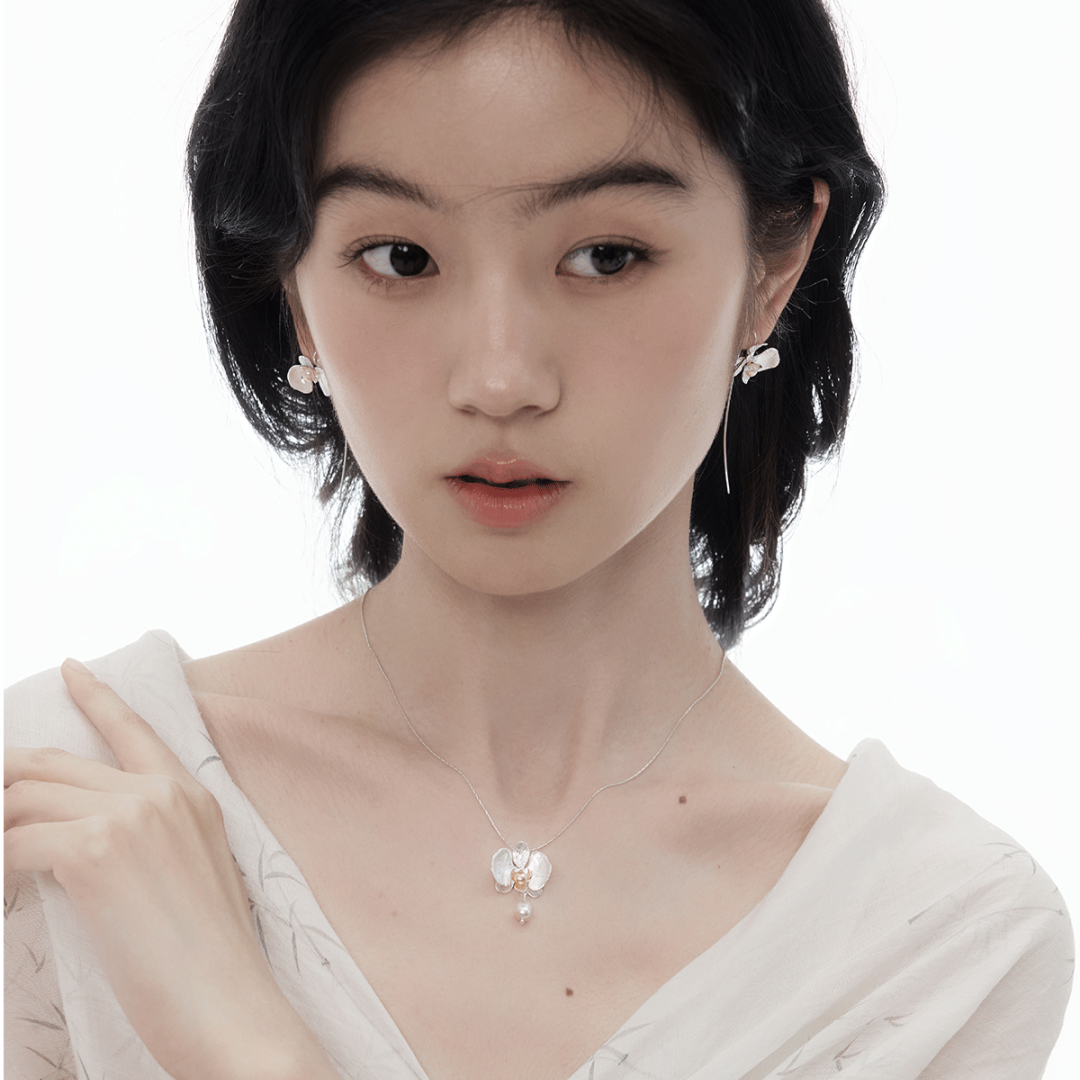 Botanical Realism Elegant Freshwater Pearl orchid necklace close-up showing matte silver texture.