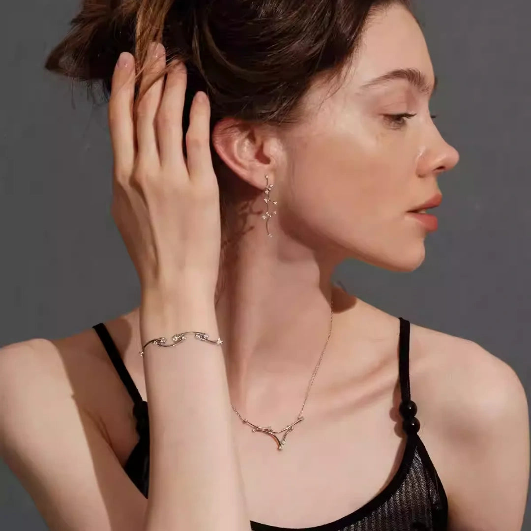 A model wearing the complete Celestial Vine bridal jewelry set including S925 sterling silver necklace, drop earrings, and vine bracelet for a wedding look.2