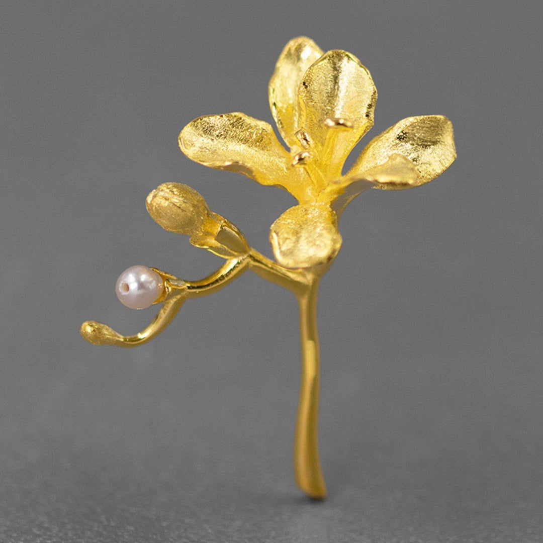 Gold plated S925 sterling silver freesia flower brooch featuring a natural pearl bud - Front view.
