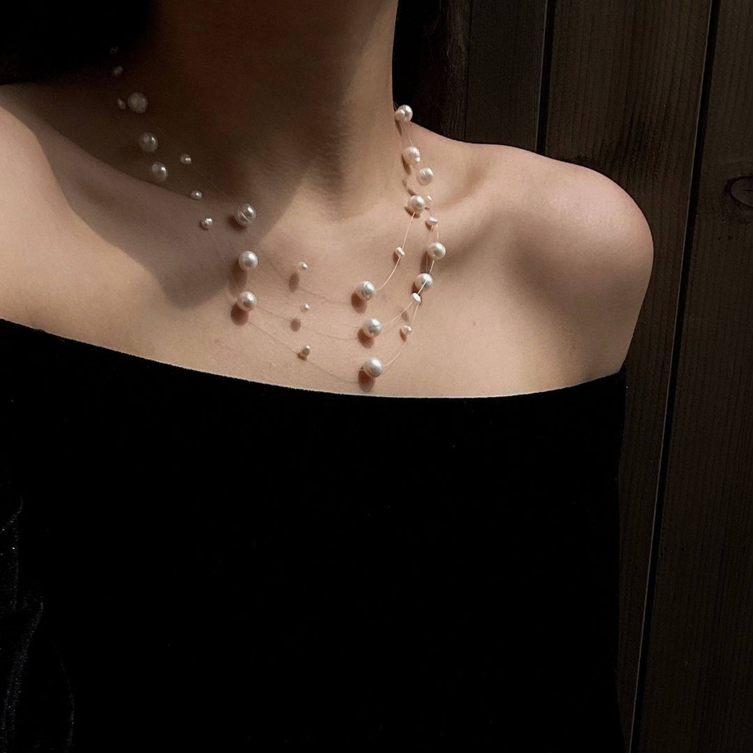 Illusion Floating Pearl elegant vintage natural freshwater pearl necklace enhancing neckline with a white romantic blouse - model-look-5