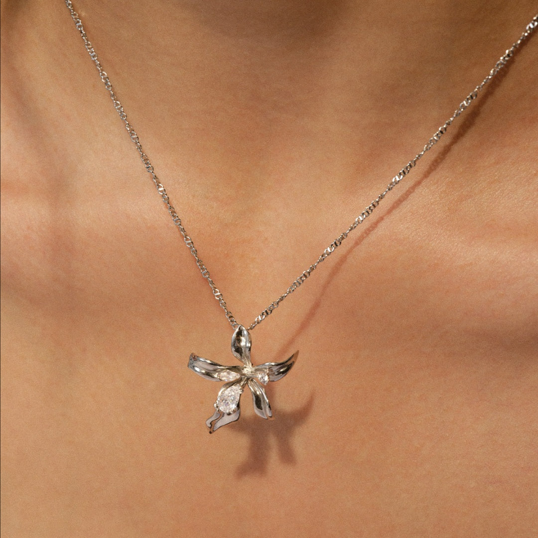 Detailed view of silver lily flower pendant showing polished petal textures - close-up-2