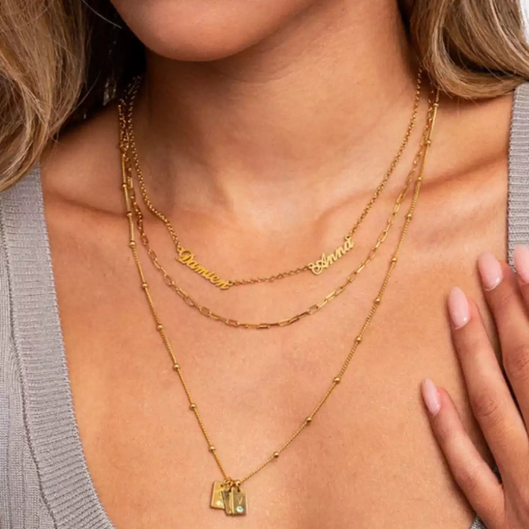 Elegant woman wearing an asymmetric 2 name necklace in sterling silver, a perfect personalised gift for mothers.