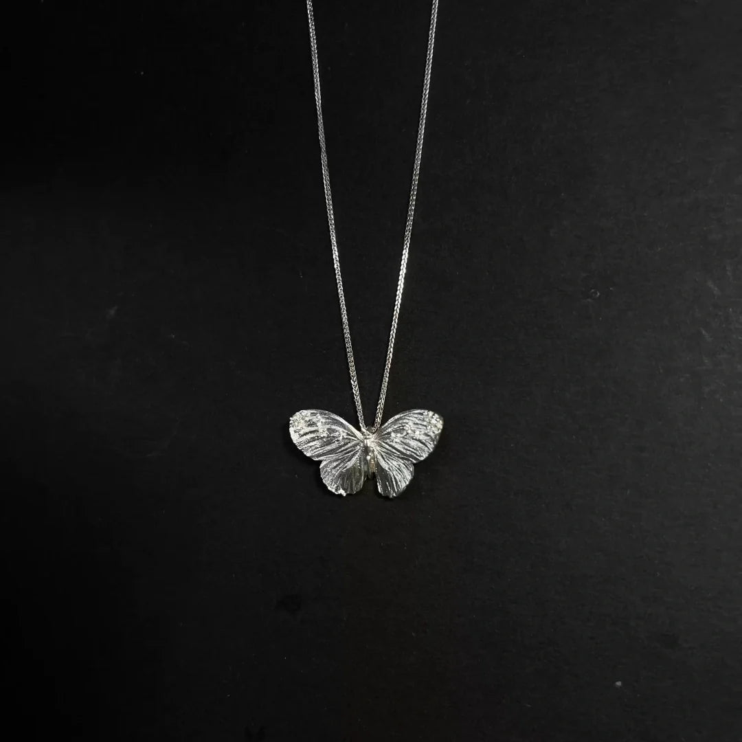 Full view of the exquisite S925 sterling silver butterfly necklace with a minimalist chain for vintage styling - product-studio-1