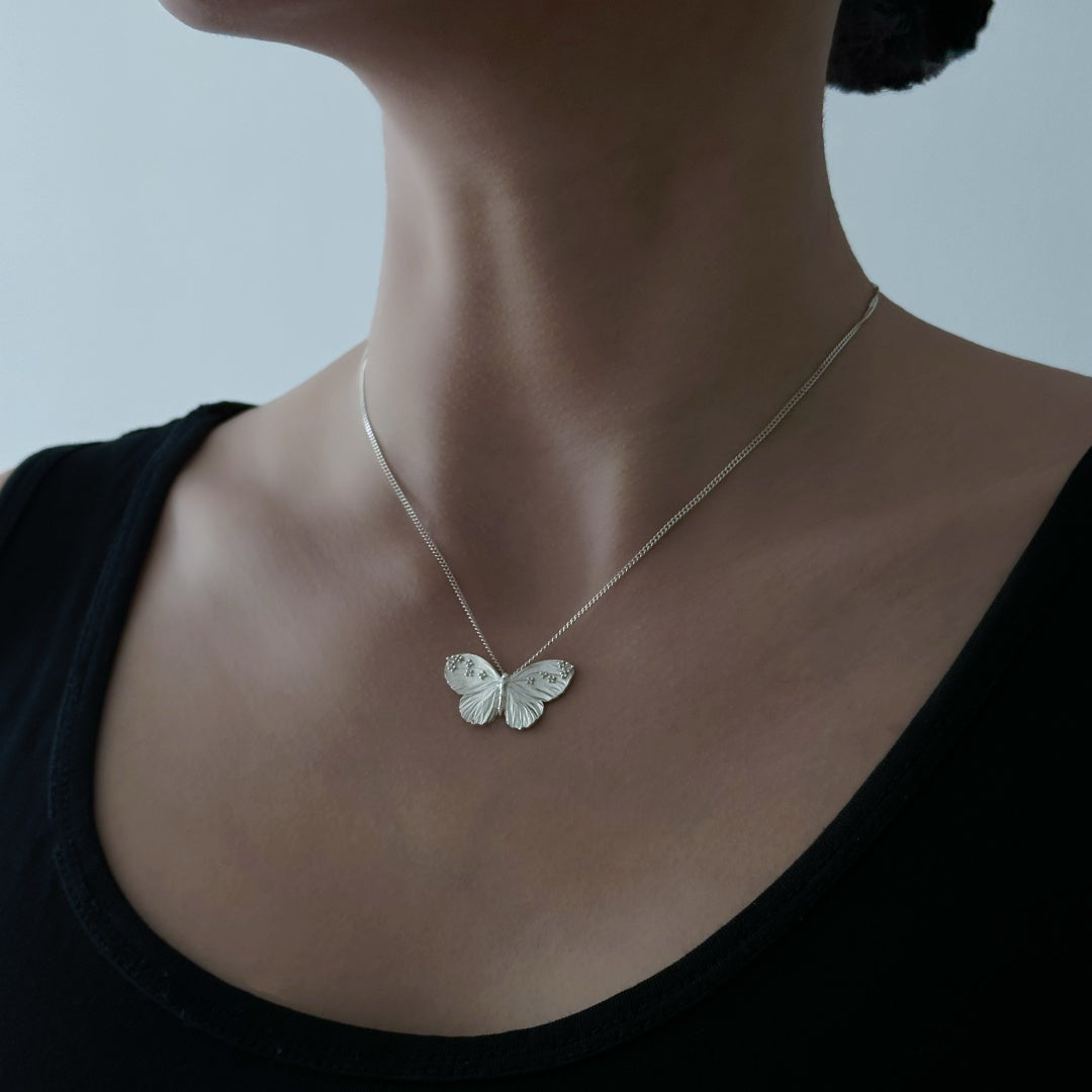 Textured Wing butterfly necklace in S925 sterling silver worn by a model to show the elegant collarbone fit - model-look-2