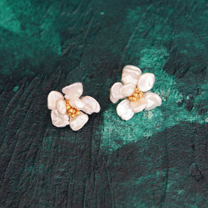 A pair of handcrafted pearl flower stud earrings featuring baroque freshwater pearls and gold bead accents in the center. These dainty pearl flower earrings are perfect bridal flower earrings and floral wedding earrings, making them an elegant choice for statement wedding bridal jewelry.