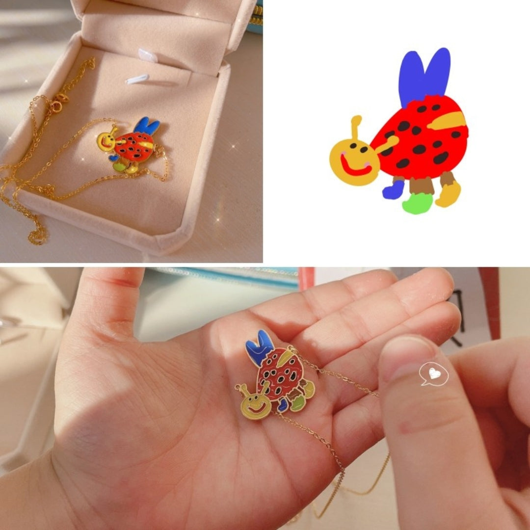 Colorful necklace with cartoon fish design in a jewelry box, held in hand.