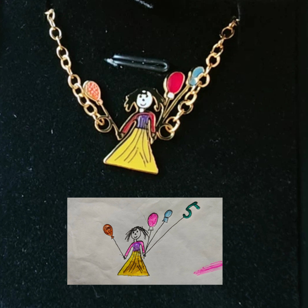 Necklace with a pendant of a cartoon character holding balloons, next to a small drawing of the same design.