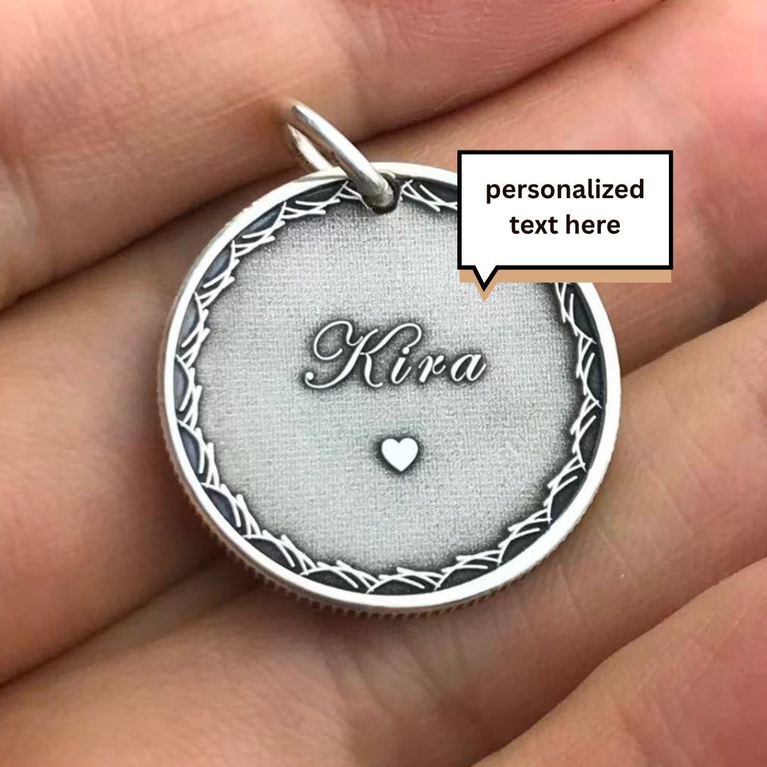 Silver pendant with 'Kira' engraved on a hand