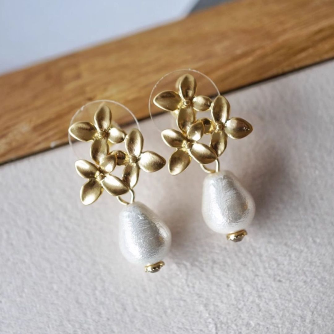 Pair of gold flower pearl earrings with teardrop pearls, ideal as wedding earrings or bridesmaid gift for a vintage-inspired look.