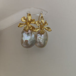 A pair of delicate gold iris flower pearl earrings with intricate flower detailing, symbolizing wisdom and hope, paired with lustrous Freshwater Cultured Pearls, ideal for a wedding or formal event.