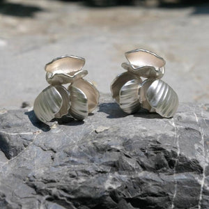 Close-up of Chunky seashell earrings in silver, designed as seashell stud earrings with a chic seashell earrings aesthetic—perfect for ocean jewelry aesthetic and Statement bridal earrings.