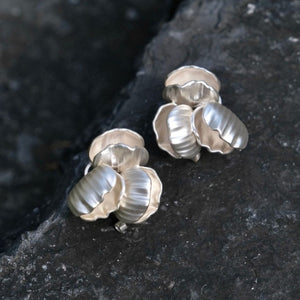 Close-up of Chunky seashell earrings in silver, designed as seashell stud earrings with a chic seashell earrings aesthetic—perfect for ocean jewelry aesthetic and Statement bridal earrings.