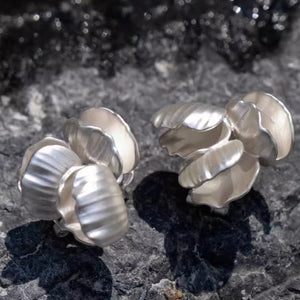 Close-up of Chunky seashell earrings in silver, designed as seashell stud earrings with a chic seashell earrings aesthetic—perfect for ocean jewelry aesthetic and Statement bridal earrings.