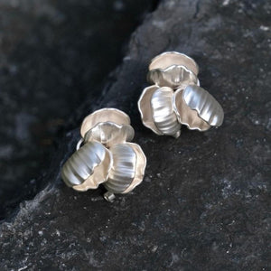 Close-up of Chunky seashell earrings in silver, designed as seashell stud earrings with a chic seashell earrings aesthetic—perfect for ocean jewelry aesthetic and Statement bridal earrings.