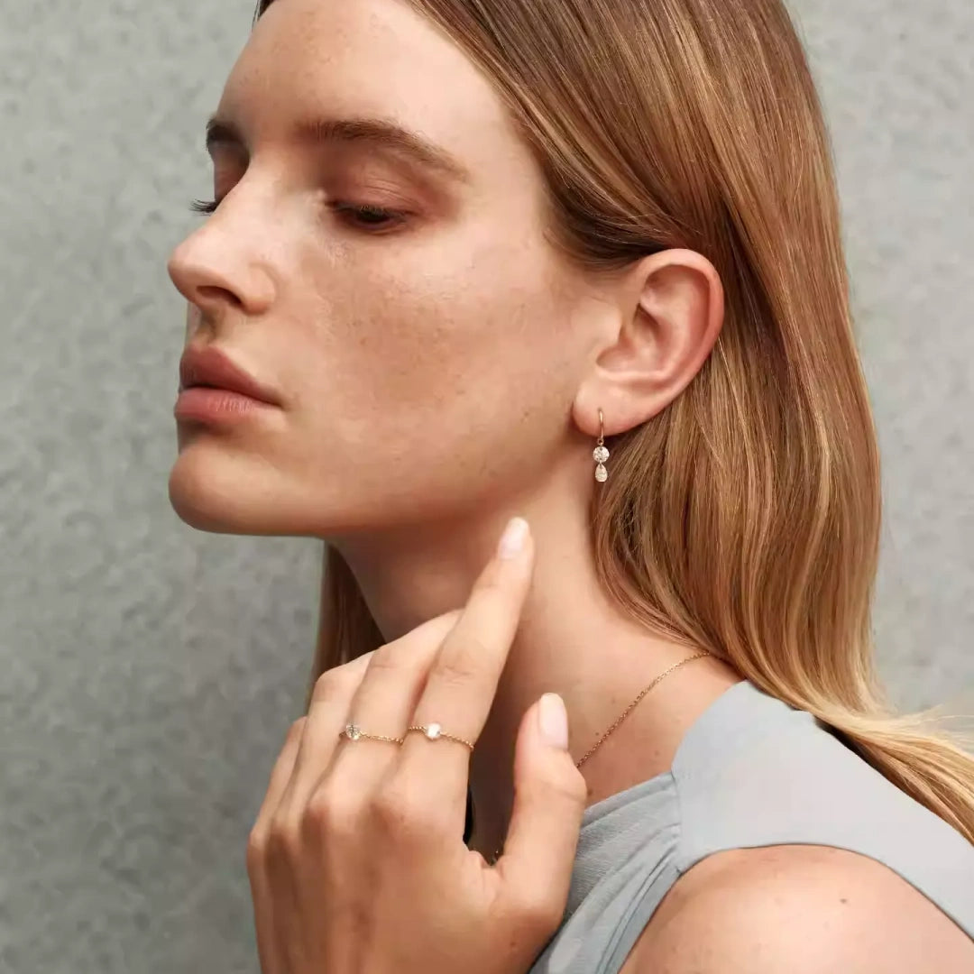 Bride wearing moissanite wedding jewelry set with smile necklace and shimmering pear drop earrings for an elegant bridal look. Model Images 4