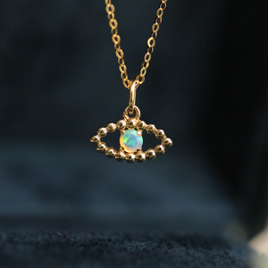 18K Yellow Gold Evil Eye charm necklace with Australian Opal Gemstone from The Chubby Paw. 